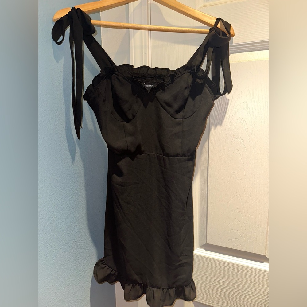 Black mini dress with ruffles along edging